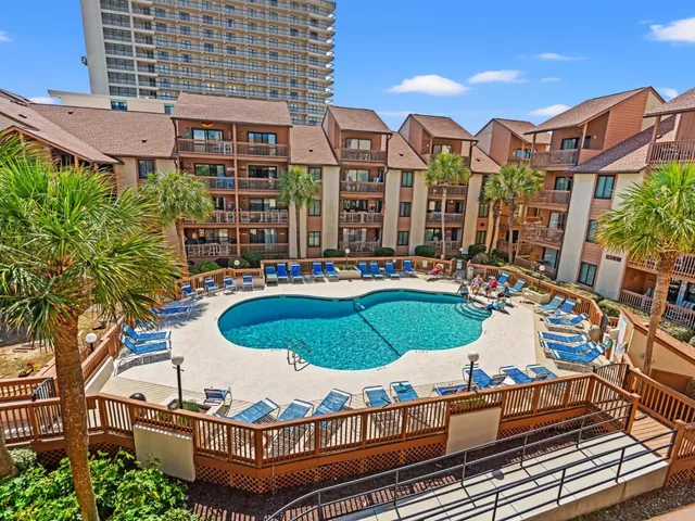 Aerial view of the pool courtyard and condominium buildings at Anchorage, a Coastal-maintained Myrtle Beach community